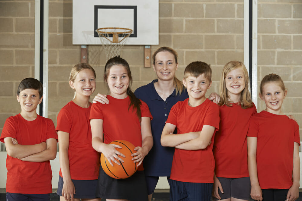 Portrait Of Elementary School Basketball Team With Coach